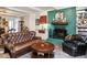 Living room featuring a fireplace, leather seating, and golf memorabilia on display at 2511 Pineway Dr, Burlington, NC 27215