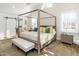 The main bedroom features a four-poster bed, vaulted ceiling, white trim and shutters, and a barn door at 2511 Pineway Dr, Burlington, NC 27215