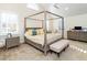 Bright main bedroom featuring a vaulted ceiling, four-poster bed, seating area, and plenty of natural light at 2511 Pineway Dr, Burlington, NC 27215