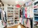Bright walk-in closet with custom shelving for shoes, clothes, and accessories, maximizing storage space at 2511 Pineway Dr, Burlington, NC 27215
