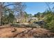 Lush backyard view of home showcasing pool and mature landscaping at 2610 University Dr, Durham, NC 27707