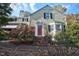 Charming home with lovely landscaping, a brick pathway, and a striking red front door at 2610 University Dr, Durham, NC 27707