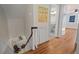 Upstairs hallway with hardwood floors leading to a bedroom and bathroom at 2610 University Dr, Durham, NC 27707