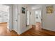 Hallway with wood floors that lead to bedrooms and ample storage at 2610 University Dr, Durham, NC 27707