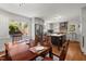 Open kitchen and dining area featuring stainless appliances, granite countertops, and wood floors at 2610 University Dr, Durham, NC 27707
