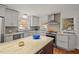 Modern kitchen featuring granite countertops, stainless steel appliances, and gray cabinets at 2610 University Dr, Durham, NC 27707