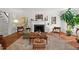 Sunlit living room with a decorative fireplace, neutral rug, and hardwood flooring at 2610 University Dr, Durham, NC 27707