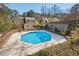 Inviting backyard pool with mature trees and covered patio area at 2610 University Dr, Durham, NC 27707