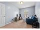 Bedroom with comfortable blue couch, carpeted floors, and lots of natural light at 3349 Tarleton W, Durham, NC 27713
