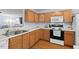 Well-equipped kitchen with wooden cabinets, a modern oven, and ample counter space for meal preparation at 3349 Tarleton W, Durham, NC 27713