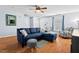 Cozy living room featuring a plush blue sectional, neutral armchairs, and natural light from the window at 3349 Tarleton W, Durham, NC 27713