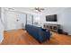 Well-lit living room with wood floors, a blue sofa, and media console, ideal for relaxing and unwinding at 3349 Tarleton W, Durham, NC 27713