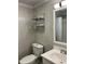 Close up view of bathroom with vanity, toilet, mirror and shelving inside a shower at 3412 Rock Creek Dr, Raleigh, NC 27609