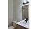 Bathroom featuring a white sink, sleek black faucet, and an elegant mirror with lighting at 3412 Rock Creek Dr, Raleigh, NC 27609