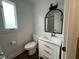 Updated bathroom featuring a modern vanity, toilet, and framed mirror at 3412 Rock Creek Dr, Raleigh, NC 27609