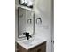 Bathroom with a modern sink, mirror, light fixture, and sleek fixtures at 3412 Rock Creek Dr, Raleigh, NC 27609