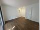 Serene bedroom with hardwood floors, neutral walls, and a sliding glass door to a private balcony at 3412 Rock Creek Dr, Raleigh, NC 27609