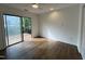 Bright bedroom with a sliding glass door leading to a balcony, wood flooring, and a ceiling fan at 3412 Rock Creek Dr, Raleigh, NC 27609