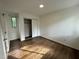 Hardwood floor bedroom with a double door closet and a bright window for plenty of natural light at 3412 Rock Creek Dr, Raleigh, NC 27609