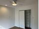 Bright bedroom with a ceiling fan, hardwood floors, closet with sliding doors, and fresh white paint at 3412 Rock Creek Dr, Raleigh, NC 27609