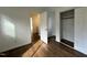 Bedroom featuring an open closet with wooden floors and a doorway leading into another room at 3412 Rock Creek Dr, Raleigh, NC 27609