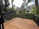 Deck with railings overlooking trees and other houses at 3412 Rock Creek Dr, Raleigh, NC 27609