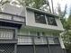 View of home exterior with multiple balconies, light gray siding and black window trim at 3412 Rock Creek Dr, Raleigh, NC 27609