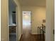 Hallway view with wood floors, modern bathroom and bedroom with ceiling fan at 3412 Rock Creek Dr, Raleigh, NC 27609