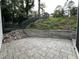 Exterior view of patio with pavers, retaining wall, and stairs leading to upper yard at 3412 Rock Creek Dr, Raleigh, NC 27609