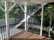 View of screened porch with wood floors, stairs and black metal railings at 3412 Rock Creek Dr, Raleigh, NC 27609