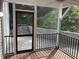 View of screened porch with wood floors and steps leading to backyard at 3412 Rock Creek Dr, Raleigh, NC 27609