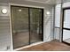View from screened porch of wooden floors and a sliding glass door at 3412 Rock Creek Dr, Raleigh, NC 27609