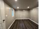 View of room with wood paneled walls, dark vinyl floors, recessed lighting and a window at 3412 Rock Creek Dr, Raleigh, NC 27609