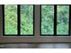 Bright and airy room showcasing large windows with picturesque green views, enhancing natural light at 3412 Rock Creek Dr, Raleigh, NC 27609