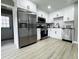 Modern kitchen featuring stainless steel appliances, white shaker cabinets, and a stylish black faucet at 3588 Northern Hills Dr, Rocky Mount, NC 27804