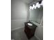 Well-lit bathroom featuring a modern vanity with black countertop and gray floor tile at 4100 Five Oaks Dr # 50, Durham, NC 27707