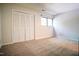Spacious bedroom with carpet flooring, large closet, and window at 4100 Five Oaks Dr # 50, Durham, NC 27707