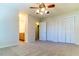 Spacious bedroom featuring carpet flooring, a closet, and a ceiling fan at 4100 Five Oaks Dr # 50, Durham, NC 27707