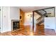 Spacious living room featuring fireplace, hardwood floors, and open staircase at 4100 Five Oaks Dr # 50, Durham, NC 27707