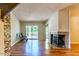 Open living room featuring a fireplace, hardwood floors, and sliding door access to the deck at 4100 Five Oaks Dr # 50, Durham, NC 27707