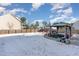 Snowy backyard featuring a covered patio, lawn, and wooden fence at 4204 Vineyard Ridge Dr, Zebulon, NC 27597