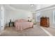 Bright bedroom with a tray ceiling, large windows, and a quaint side table with a reading lamp at 4204 Vineyard Ridge Dr, Zebulon, NC 27597