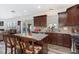 Well-equipped kitchen with granite counters, cherry cabinets, and an island with a breakfast bar at 4204 Vineyard Ridge Dr, Zebulon, NC 27597