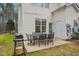 Back patio with outdoor table and chairs, perfect for entertaining or enjoying nature at 4555 Sugarbend Way, Raleigh, NC 27606