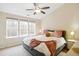Comfortable bedroom featuring a ceiling fan and an abundance of natural light from multiple windows at 4555 Sugarbend Way, Raleigh, NC 27606