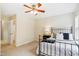 Bedroom features a ceiling fan, access to bathroom, and a large window at 4555 Sugarbend Way, Raleigh, NC 27606