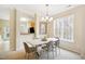 Dining area with modern chandelier, adjacent to kitchen, offering a seamless flow for entertaining at 4555 Sugarbend Way, Raleigh, NC 27606