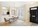 Bright dining area with modern chandelier, neutral walls, and adjacent kitchen view at 4555 Sugarbend Way, Raleigh, NC 27606