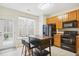 Functional kitchen featuring an island, black appliances, wood cabinets and a view to backyard at 4555 Sugarbend Way, Raleigh, NC 27606