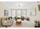 Inviting living room featuring large windows, neutral decor, and comfortable seating arrangements at 4555 Sugarbend Way, Raleigh, NC 27606